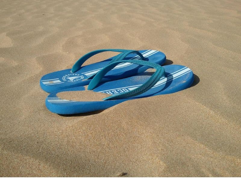 A pair of classic flip flops featuring a flat sole and Y-shaped thong strap that separates the big toe for easy wear