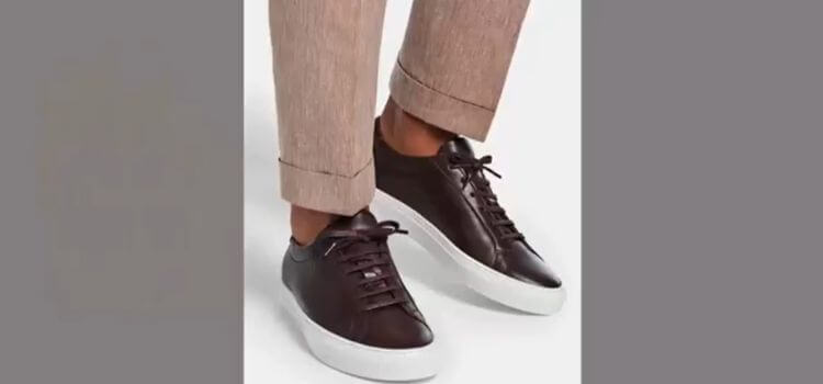 Sleek brown leather sneakers paired with beige trousers – How to Wear a Polo Shirt Tucked In for a smart casual look