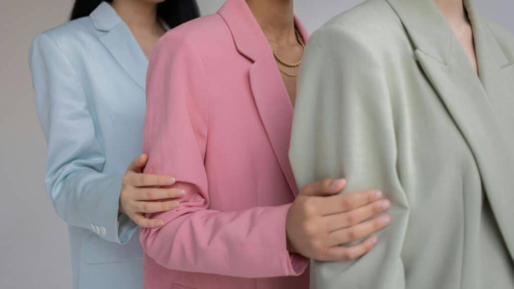 Three women in oversized blazers showing how to style an oversized blazer for work, featuring elegant professional looks.
