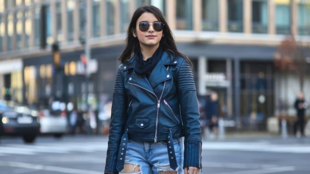 Woman wearing a biker jacket styled with casual streetwear